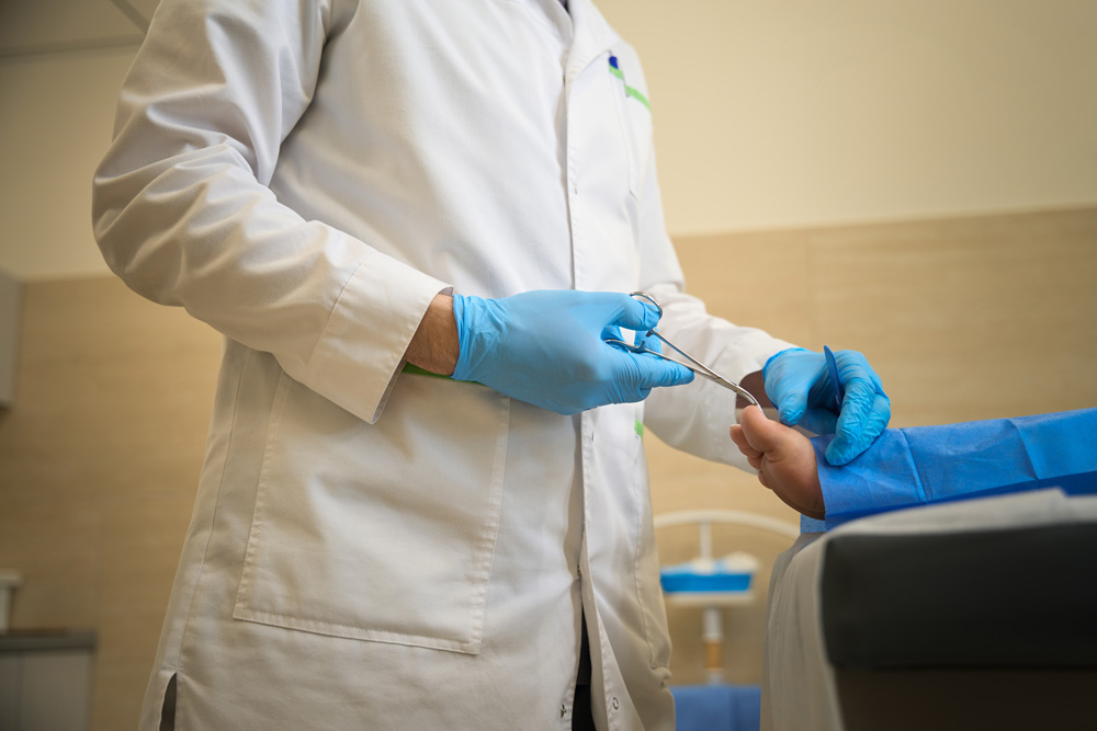 healthcare worker cutting toenail